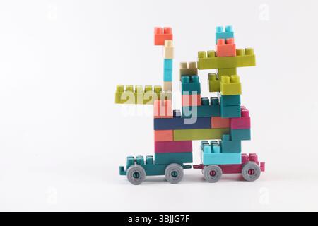 Plastic building blocks form vehicle on white background Stock Photo