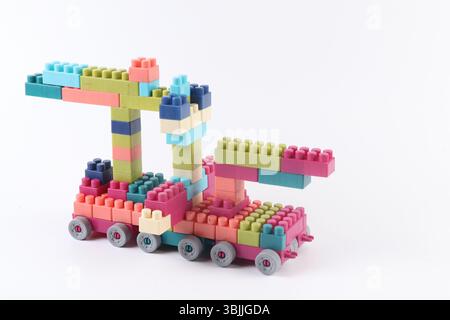 Plastic building blocks form vehicle on white background Stock Photo