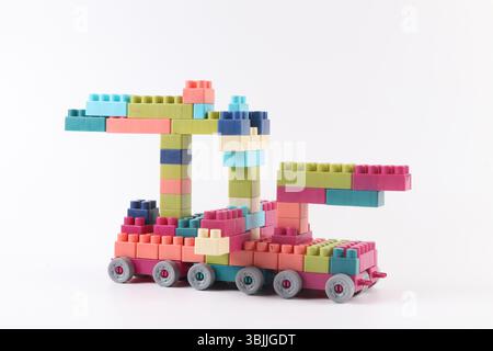 Plastic building blocks form vehicle on white background Stock Photo