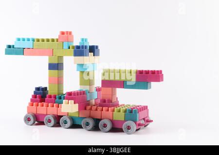 Plastic building blocks form vehicle on white background Stock Photo