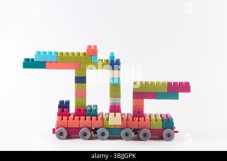 Plastic building blocks form vehicle on white background Stock Photo