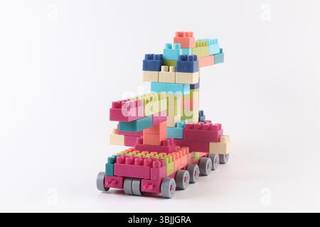 Plastic building blocks form vehicle on white background Stock Photo