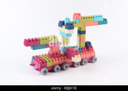 Plastic building blocks form vehicle on white background Stock Photo