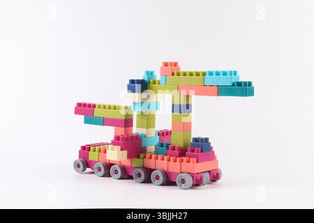 Plastic building blocks form vehicle on white background Stock Photo