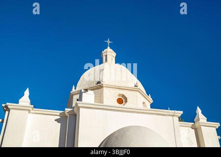 Looking up at white church dome against blue sky Stock Photo