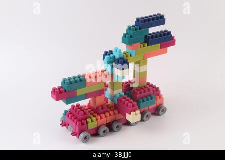 Plastic building blocks form vehicle on white background Stock Photo
