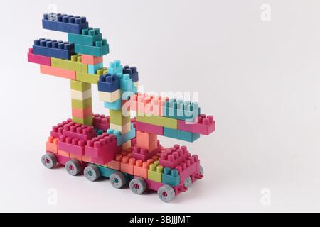 Plastic building blocks form vehicle on white background Stock Photo
