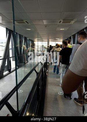 Travelers waiting in line in waiting area, Cebu Pacific Air gates ...