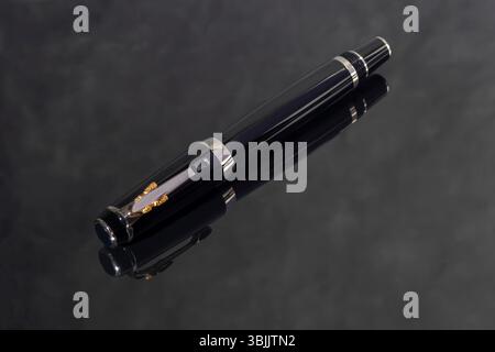 Branded pen in a box. Gift set. Selective focus. Office interior. Copy space Stock Photo