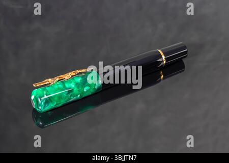 Branded pen in a box. Gift set. Selective focus. Office interior. Copy space Stock Photo