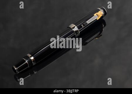 Branded pen in a box. Gift set. Selective focus. Office interior. Copy space Stock Photo