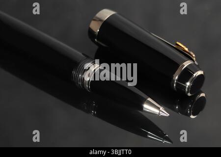 Branded pen in a box. Gift set. Selective focus. Office interior. Copy space Stock Photo