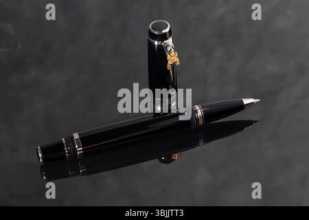 Branded pen in a box. Gift set. Selective focus. Office interior. Copy space Stock Photo