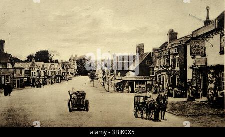 A view of a wide street with horse-drawn carriages and the White Horse Hotel, the Kings Arms public house and shops, all in Haslemere, Surrey. Published by Francis Frith and Co. of Reigate, Surrey, around 1906. From a mixed collection of social history postcards, mainly from the early twentieth century. Stock Photo