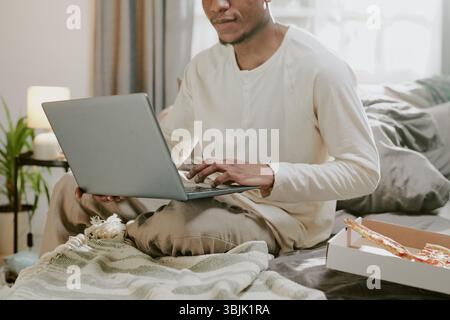 Remote Working from Home with Laptop on Bed Stock Photo