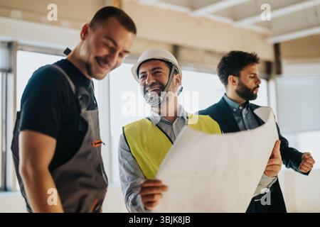 Engineers and architects collaborating on a construction site project Stock Photo