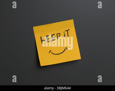 Positive reminder on sticky note in a minimal setting. High quality photo Stock Photo