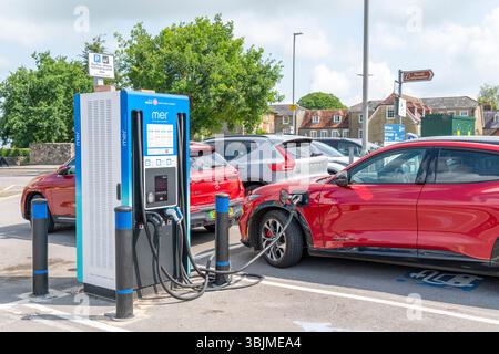 Electric car charging point in public car park Stock Photo
