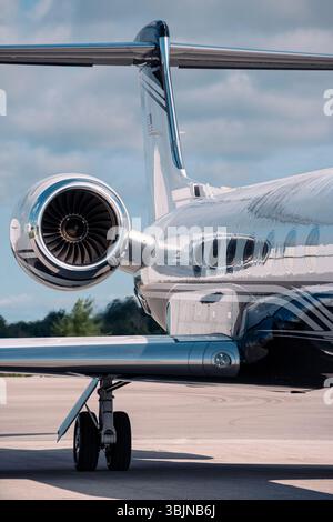 Turbofan jet engine and tail section on a private business jet with red ...