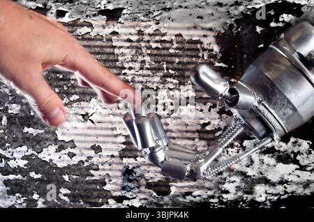 Connection between human and robot against rusty background Stock Photo