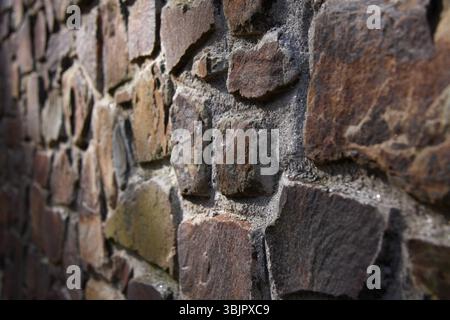 Orange and grey sandstone stone wall close up abstract texture Stock Photo