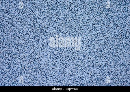 Blue sports field rubber coating close up. Playground paving background texture. Stock Photo