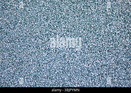 Blue sports field rubber coating close up. Playground paving background texture. Stock Photo