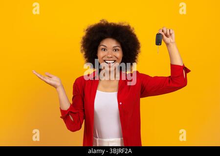 New Vehicle. Excited Young Black Woman Holding Car Key In Her Hand Stock Photo