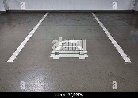 Electric car charging station in a carpark Stock Photo