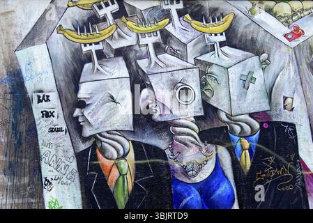 Social satire with cube-shaped heads and suits, in shades of grey, graffiti on the Berlin Wall in the East Side Gallery, Berlin, Germany, Europe, Abst Stock Photo