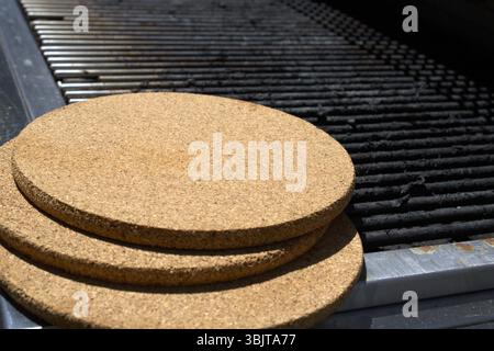 pile of cork trivets on grill Stock Photo