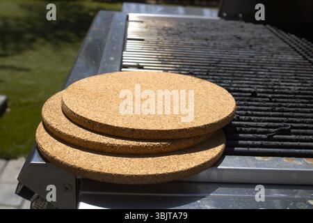 pile of cork trivets on grill Stock Photo