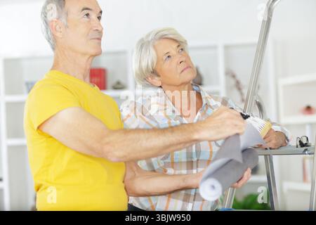 happy senior couple doing diy Stock Photo
