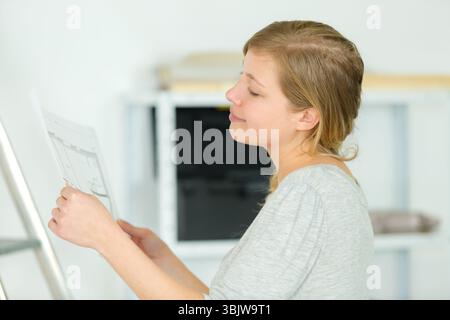 woman checking the plans of her house Stock Photo