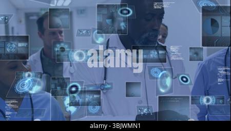 Analyzing diverse medical team reviewing holographic data in corridor, with stethoscope and tablet Stock Photo