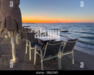 Restaurant on the beach on Chalkidiki island at sunset in Greece Stock Photo