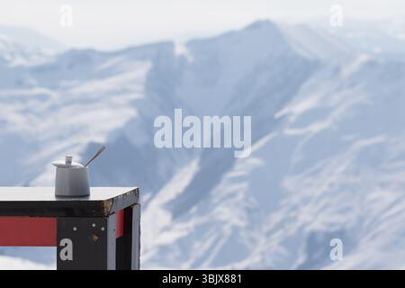 Old table with sugar bowl in outdoor cafe at ski resort Stock Photo