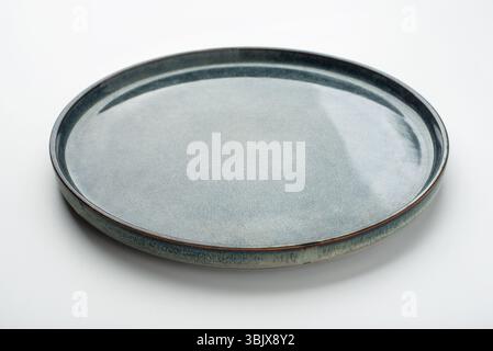 Empty textured plate on white background Stock Photo