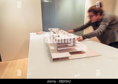 Female architect working on architecture model on table Stock Photo