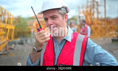 Portrait of crane worker on construction crane use walkie talkie to talk for made to transport the crane from storage to be asse Stock Photo