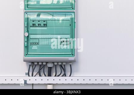 New industrial electricity distribution panel board on a white wall Stock Photo