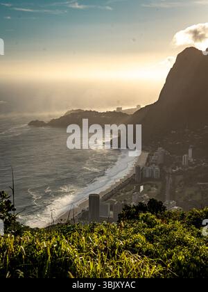 Golden Sunset Over Rio De Janeiro From Two Brothers Mountain: Dramatic Sunbeams Streaming Through Coastal Peaks Above The Atlantic Ocean And Leblon Be Stock Photo