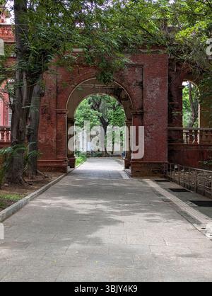 A walk through time. Weathered bricks, graceful arches, and dappled light — a quiet passage where the past lingers gently. Stock Photo