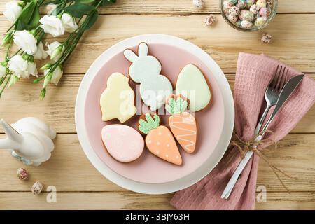 Easter brunch table setting. Spring Easter holiday concept with white, pink plate and napkin with decorative symbols holiday rab Stock Photo