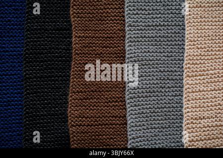 Mix of black, gray, blue Indigo, brown and beige knitted wool texture background pattern horizontal background. Selective focus. Stock Photo