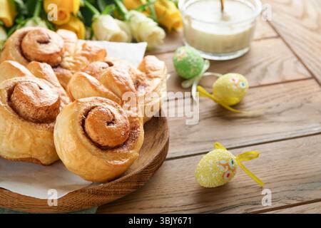 Easter breakfast Holliday concept. Easter bunny buns rolls with cinnamon made from yeast dough with orange glaze, easter decorat Stock Photo