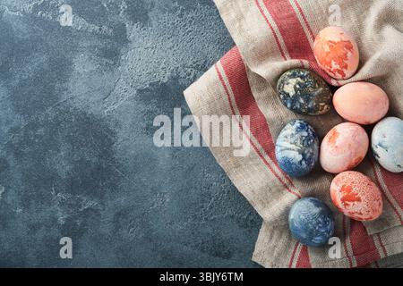 Easter eggs. Dyed Easter eggs with marble stone effect ref and blue color in rustic style on dark  stone background. Easter back Stock Photo