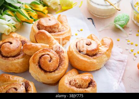 Easter breakfast Holliday concept. Easter bunny buns rolls with cinnamon made from yeast dough with orange glaze, easter decorat Stock Photo