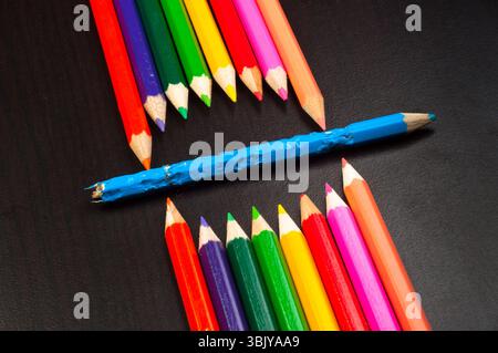 Monster made out of pencils on black board Stock Photo