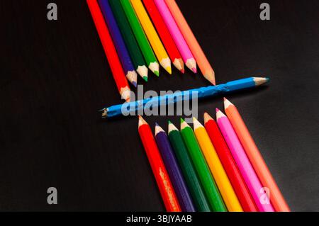 Monster made out of pencils on black board Stock Photo